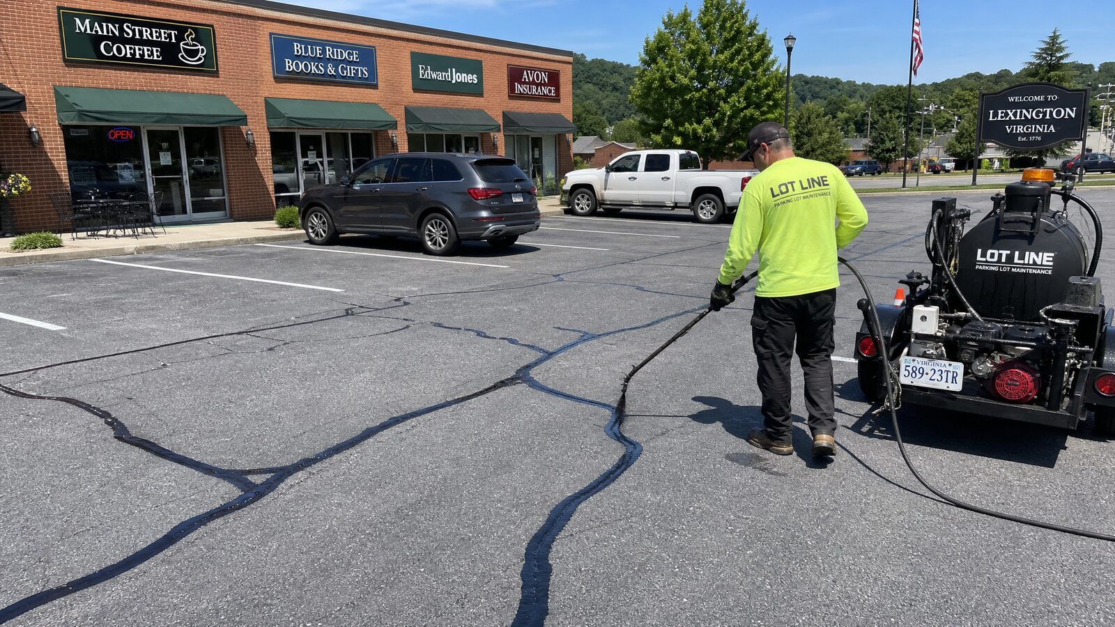 Commercial parking lot in the New River Valley having its cracks sealed by a maintenance crew